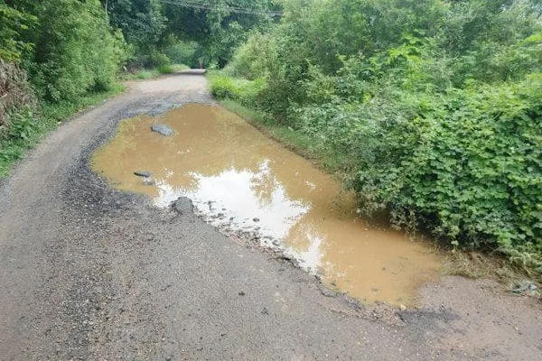 Watch out for: Rainwater pooling in village road ditches   கவனம் செலுத்துங்க: கிராம ரோடு பள்ளங்களில் தேங்கும் மழைநீர்